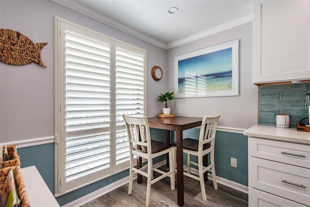 dining area featuring ornamental molding, a wealth of natural light, and wood-type flooring