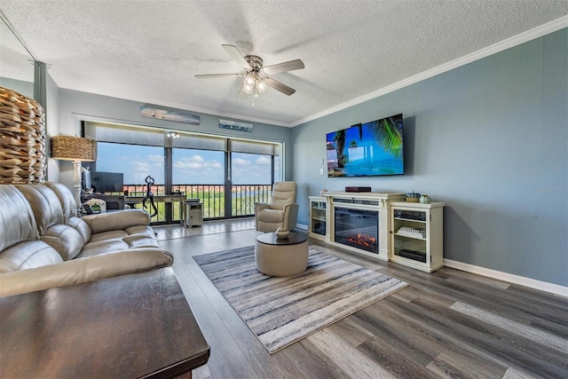 living room with wood-type flooring, ceiling fan, and a textured ceiling