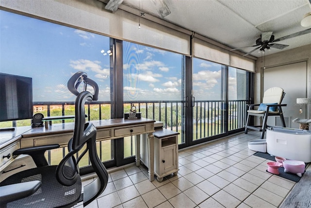 sunroom / solarium featuring ceiling fan