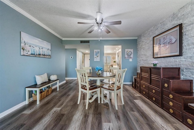 dining area featuring ornamental molding, ceiling fan, a textured ceiling, and dark hardwood / wood-style floors