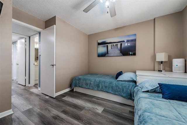 bedroom with hardwood / wood-style flooring, a textured ceiling, and ceiling fan