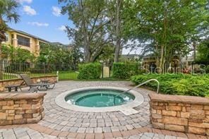 view of swimming pool featuring an in ground hot tub and a patio area