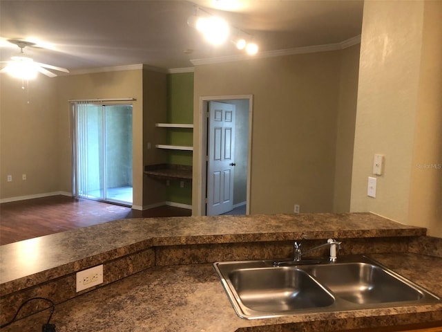 kitchen featuring sink, hardwood / wood-style floors, crown molding, and ceiling fan