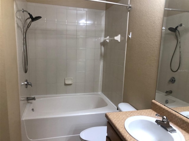 full bathroom with vanity, toilet, and tiled shower / bath