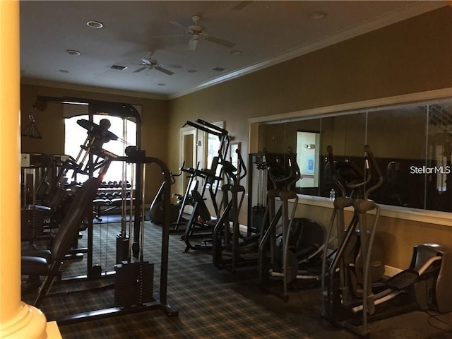 exercise room featuring ornamental molding, dark colored carpet, ornate columns, and ceiling fan