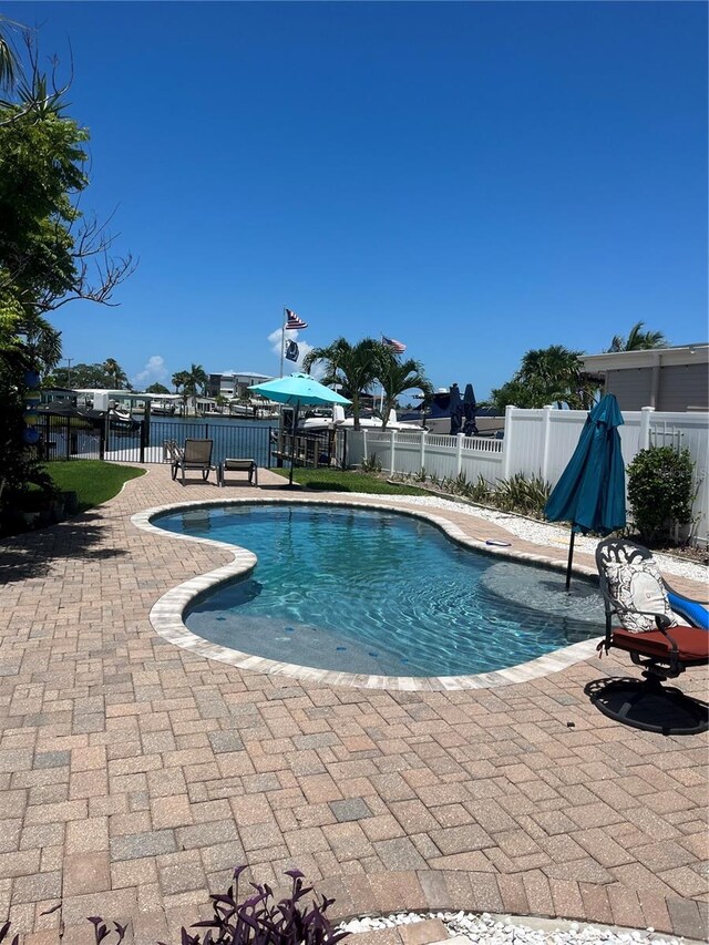 view of swimming pool featuring a fenced in pool, a fenced backyard, and a patio