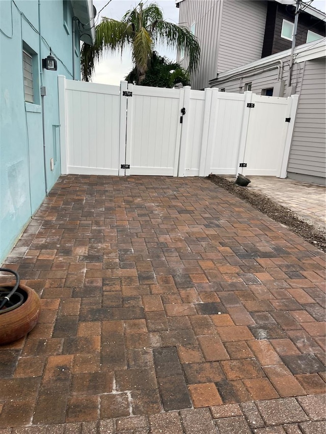 view of patio featuring a gate and fence