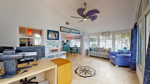 office featuring a ceiling fan, visible vents, a textured wall, and high vaulted ceiling