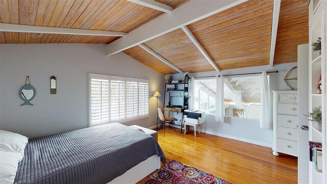 bedroom with lofted ceiling with beams, wood ceiling, multiple windows, and wood finished floors