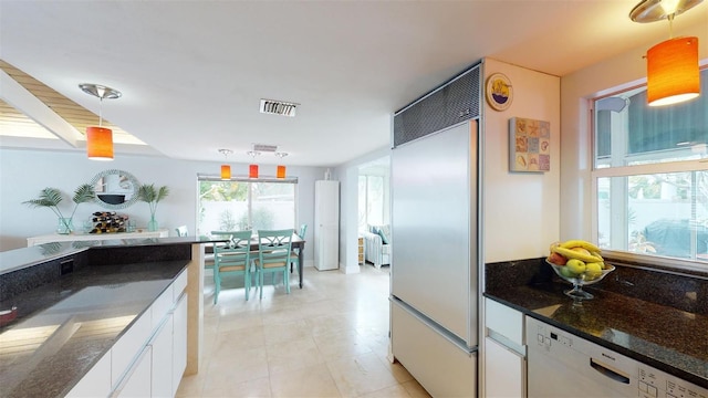 kitchen featuring visible vents, white cabinets, dishwasher, pendant lighting, and built in fridge