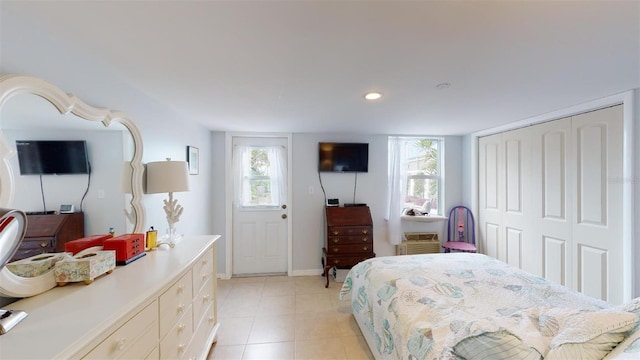 bedroom with baseboards, light tile patterned flooring, a closet, and recessed lighting