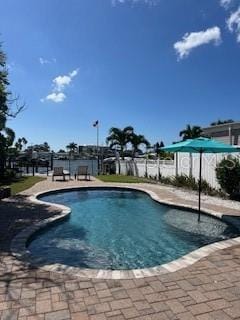 view of pool featuring a patio, fence, and a fenced in pool