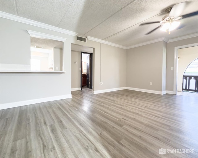 unfurnished living room with crown molding, a textured ceiling, wood-type flooring, and ceiling fan