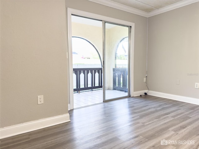 unfurnished room featuring crown molding and hardwood / wood-style flooring