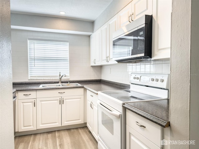 kitchen with white cabinets, white electric range, sink, and light wood-type flooring