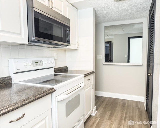 kitchen with a textured ceiling, white electric stove, light hardwood / wood-style flooring, and white cabinets