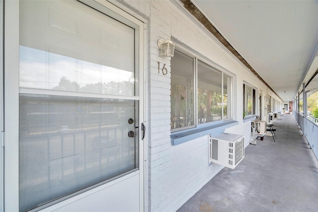 entrance to property featuring an AC wall unit