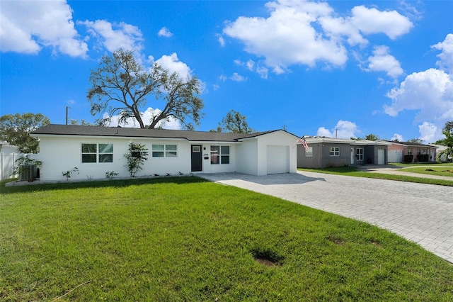 ranch-style home with a garage and a front yard