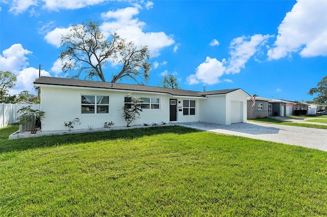 single story home with a garage and a front lawn