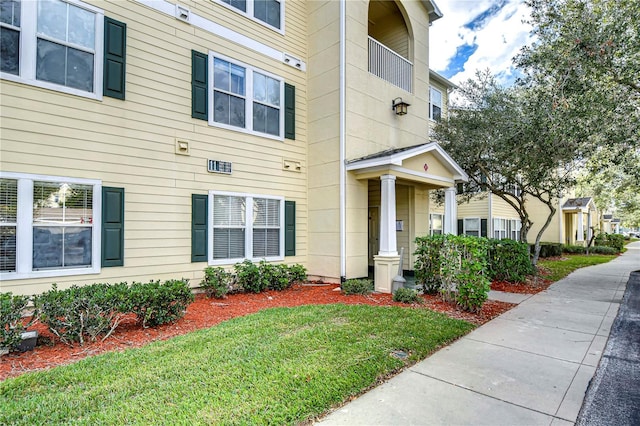 doorway to property featuring a yard