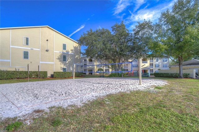 view of home's community with a yard and volleyball court