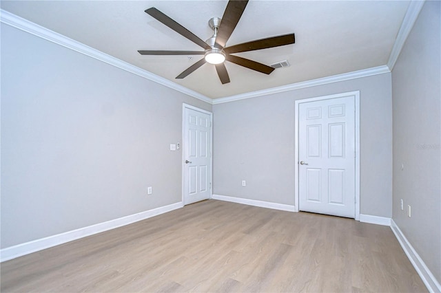 spare room featuring ceiling fan, light wood-type flooring, and crown molding