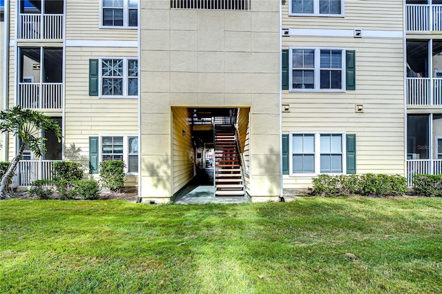 doorway to property featuring a yard