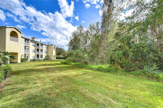 view of yard with a balcony