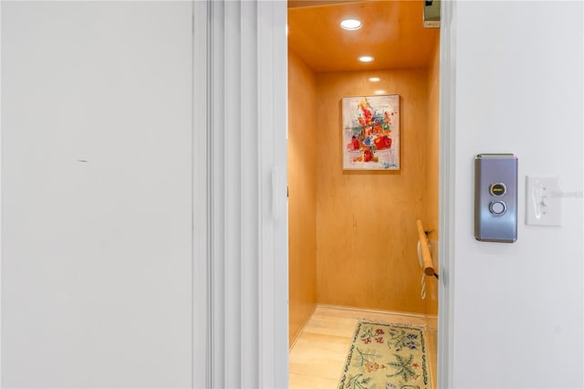 details with wood-type flooring and elevator