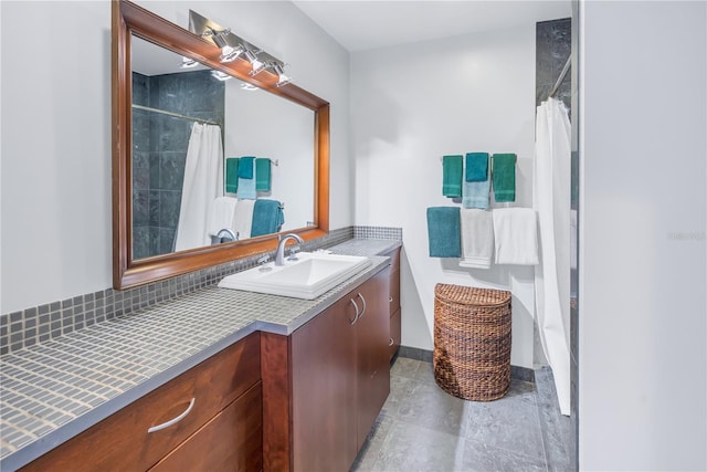 bathroom with walk in shower and vanity