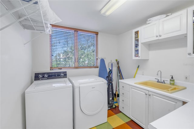 laundry room featuring cabinets, sink, and washer and dryer