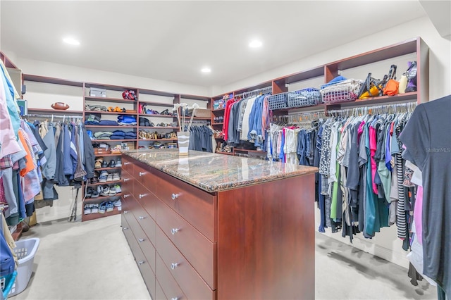 walk in closet with light colored carpet