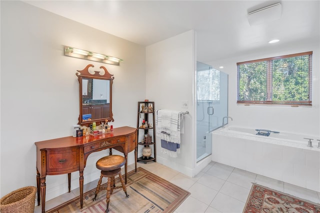 bathroom featuring vanity, shower with separate bathtub, and tile patterned floors