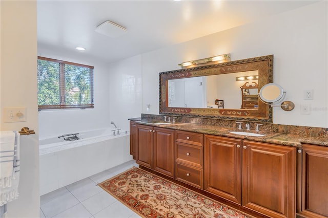 bathroom featuring vanity, tile patterned floors, and tiled tub