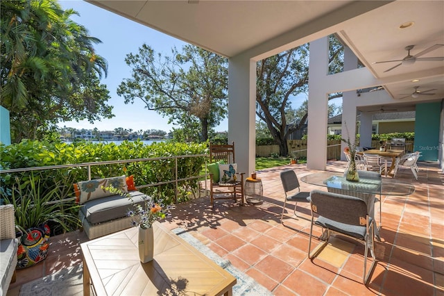 view of patio featuring a water view and ceiling fan