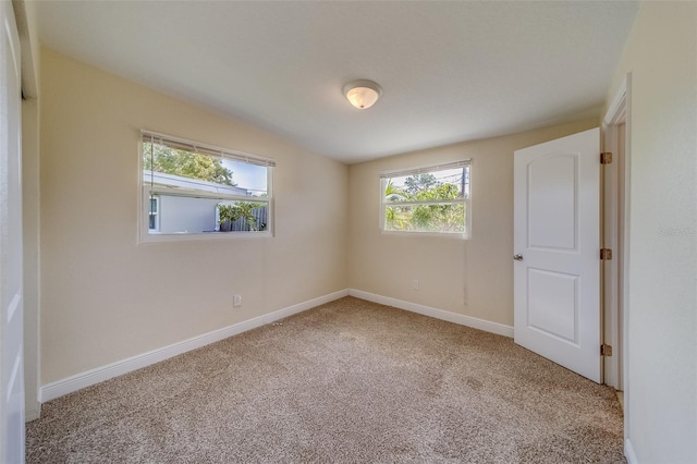 unfurnished room featuring carpet