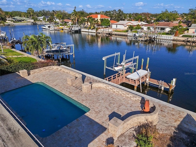 view of dock with a water view and a patio