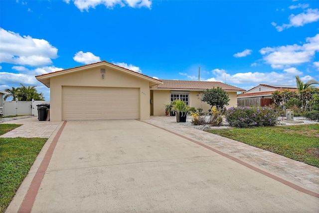 ranch-style house featuring a front yard and a garage