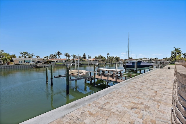 dock area with a water view and boat lift