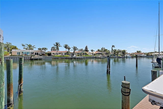 view of dock featuring a residential view and a water view