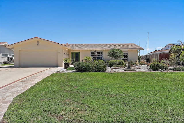 single story home with a tile roof, driveway, stucco siding, an attached garage, and a front lawn