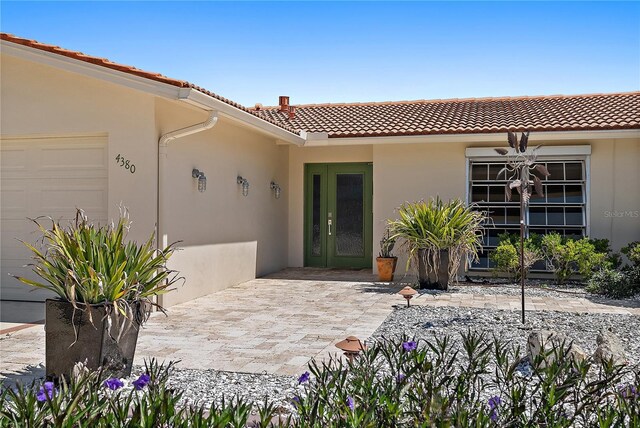 exterior space featuring stucco siding and a tile roof