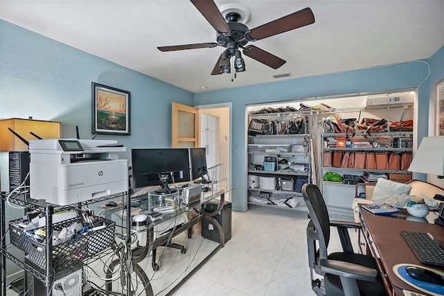 office with a ceiling fan, light tile patterned floors, and visible vents