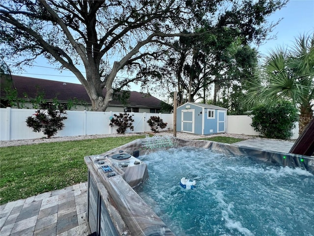 view of pool featuring a shed and a yard