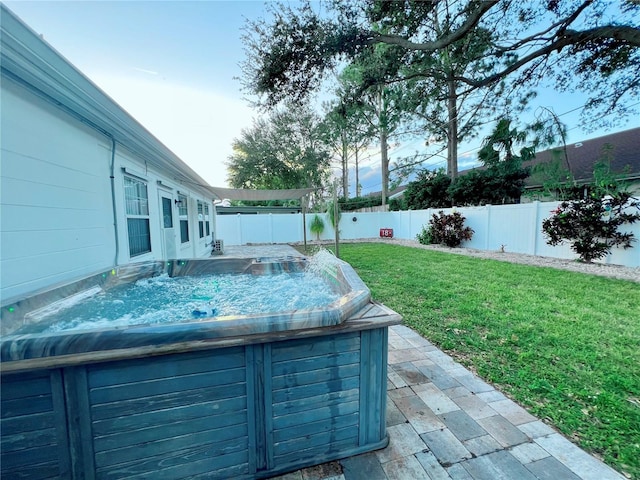 view of yard featuring a hot tub and a fenced backyard