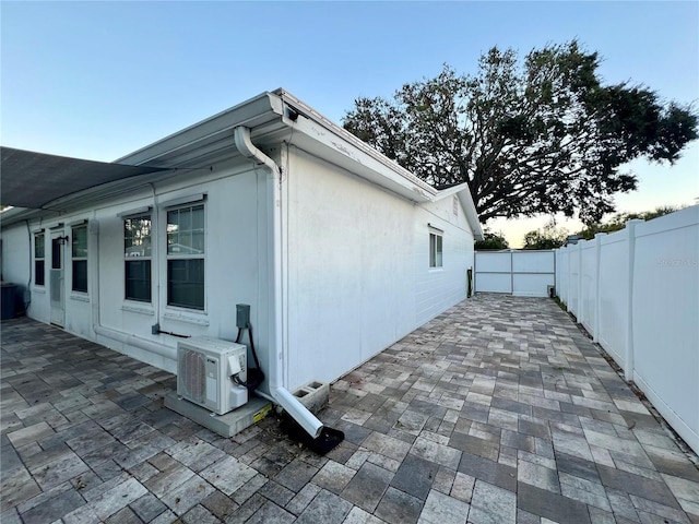 view of home's exterior featuring ac unit, a patio, and fence