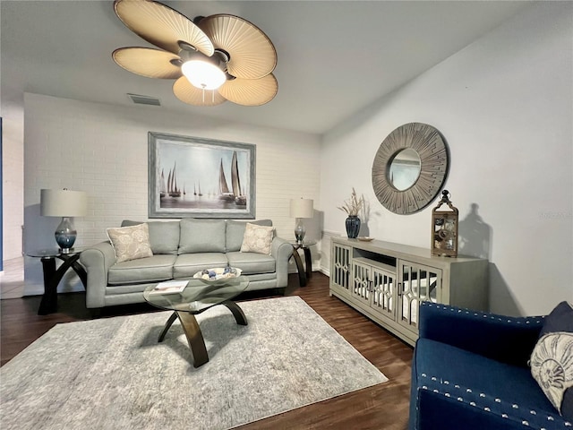 living room with dark wood-style floors and visible vents