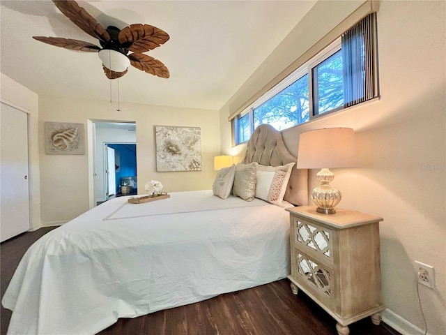 bedroom featuring ceiling fan, baseboards, and dark wood-style flooring