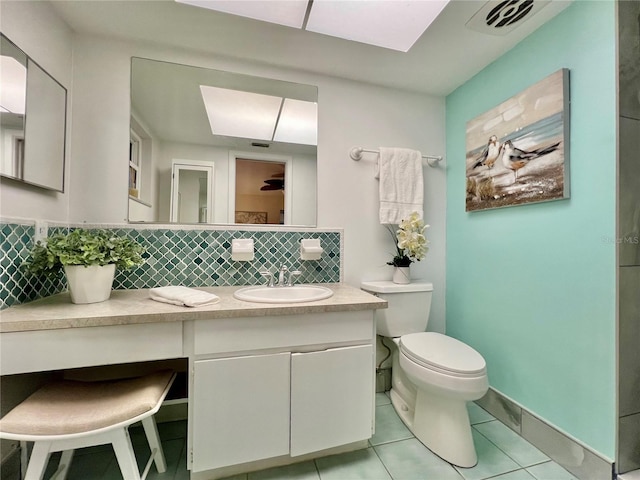 bathroom featuring visible vents, toilet, tile patterned floors, vanity, and backsplash