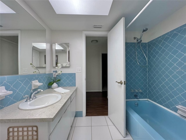 full bath featuring  shower combination, vanity, backsplash, and tile patterned floors